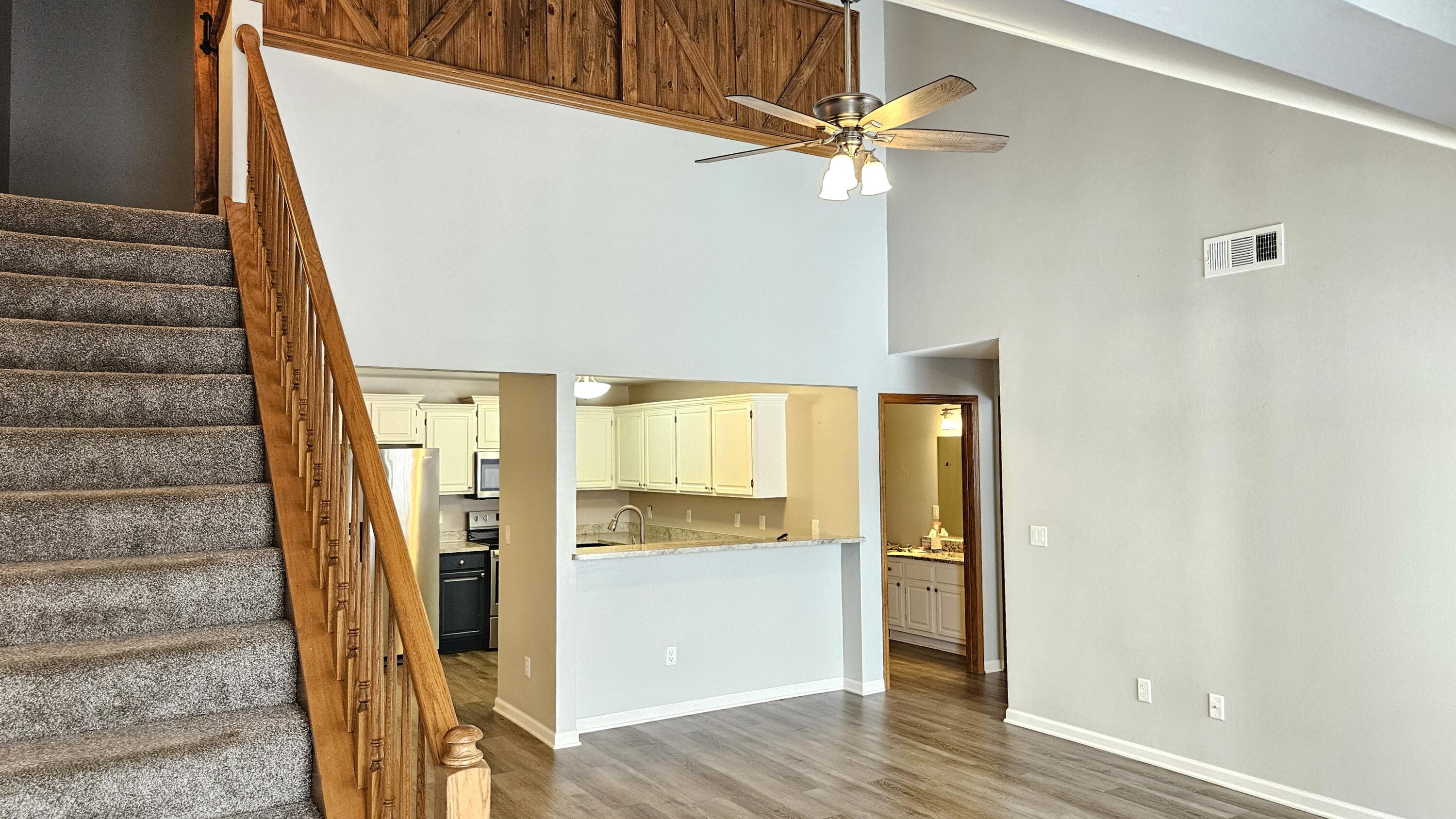 4887 Easy Street, Unit 11 Delafield, WI 53029 - Photo 3 of 26 Living room towards kitchen. Custom wood sliding panels isolate the upstairs Master Bedroom.
