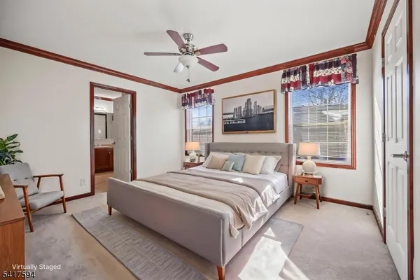 a bedroom with a large bed and a chandelier