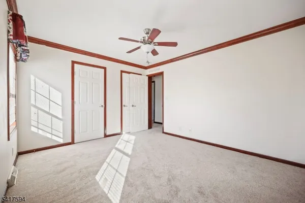 a view of a livingroom with a ceiling fan and window