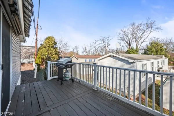 a view of a balcony with wooden floor and fence