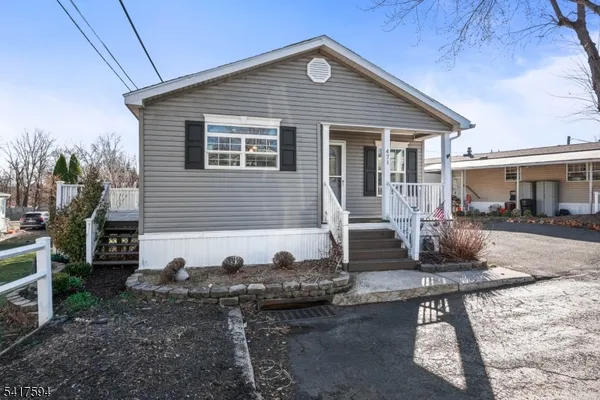 a front view of house with yard outdoor seating and barbeque oven