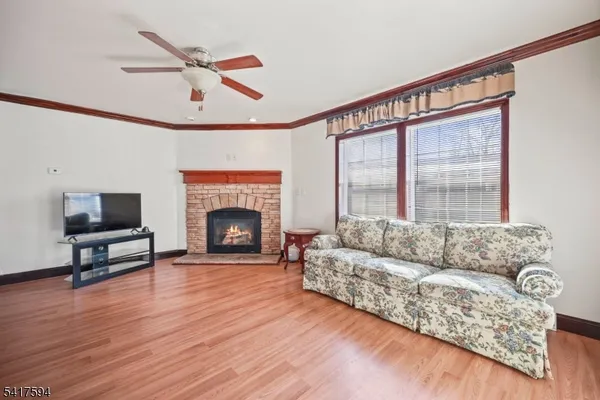 a living room with furniture a fireplace and a large window