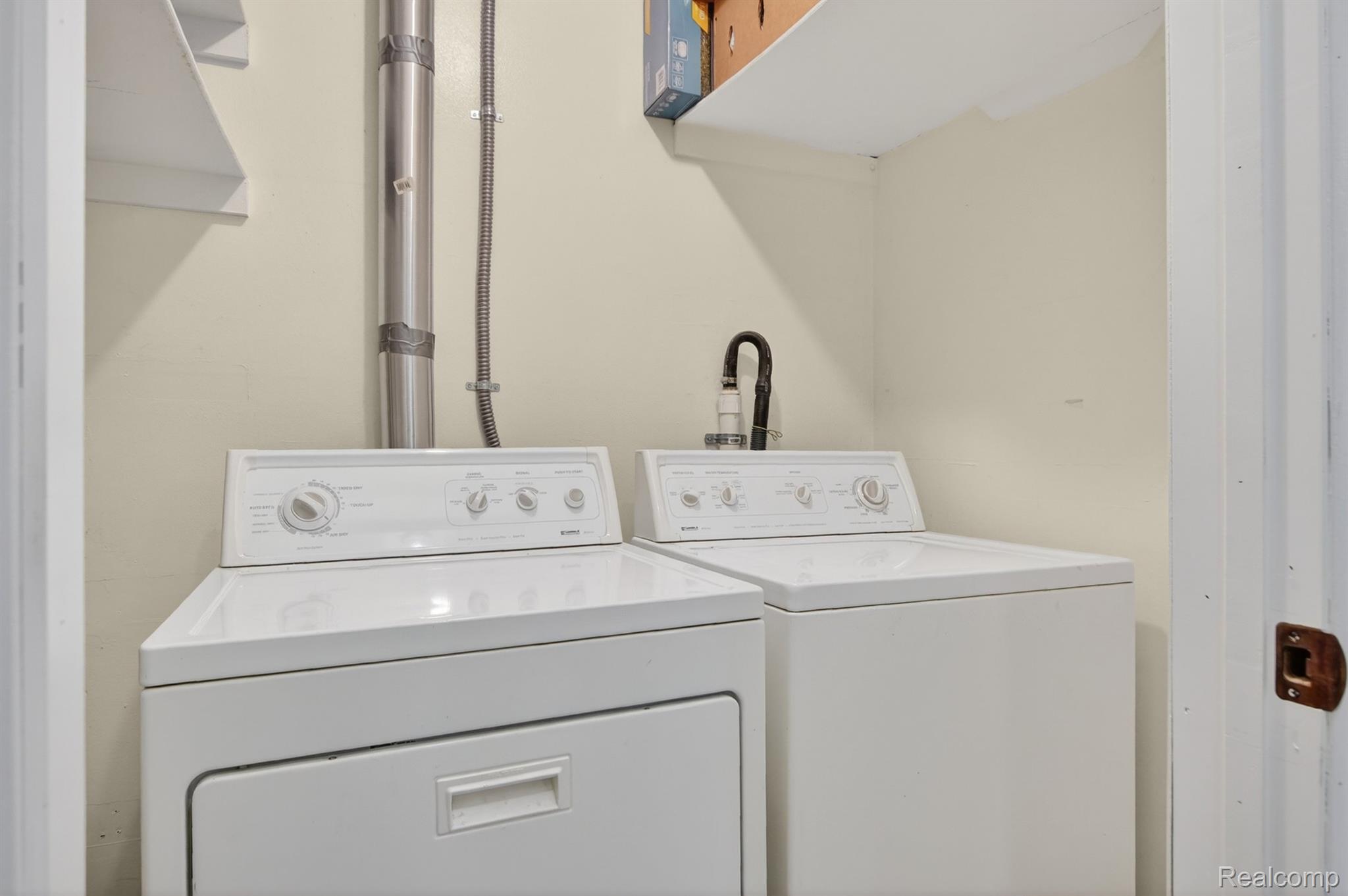 24111 Meridian Road, Unit 116 Grosse Ile, MI 48138 - Photo 24 of 26 Dedicated laundry area featuring a white washer and dryer set