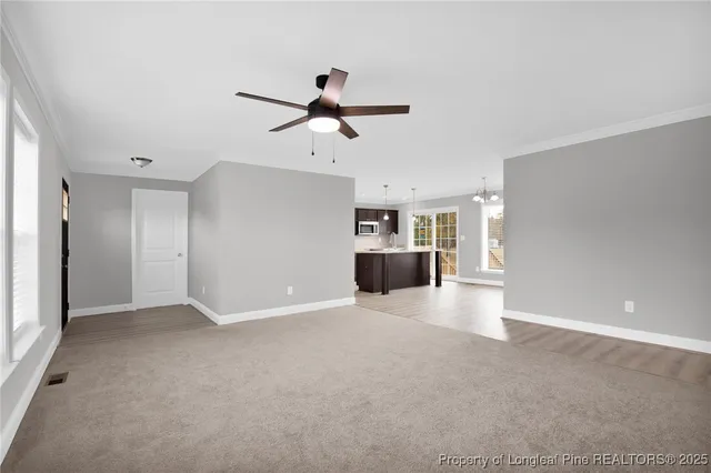 a view of a kitchen with a sink and a refrigerator