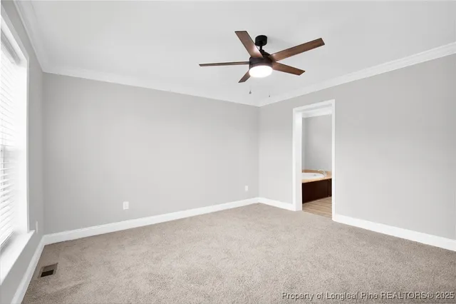a view of a livingroom with a ceiling fan and window