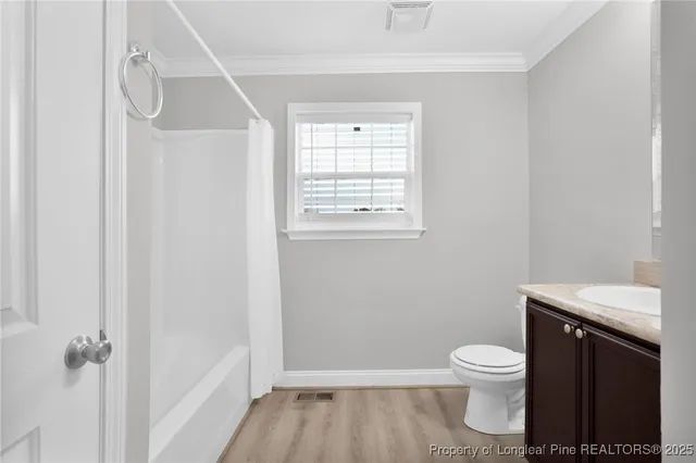 a bathroom with a toilet a sink and a window