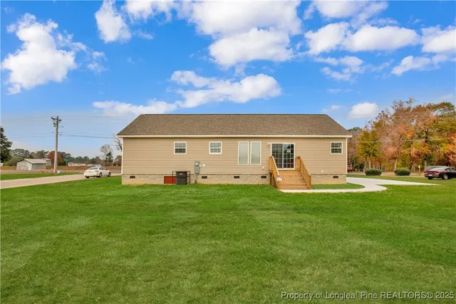 a view of a back yard of the house with a yard