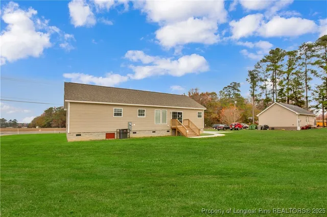 a front view of house with yard and trees