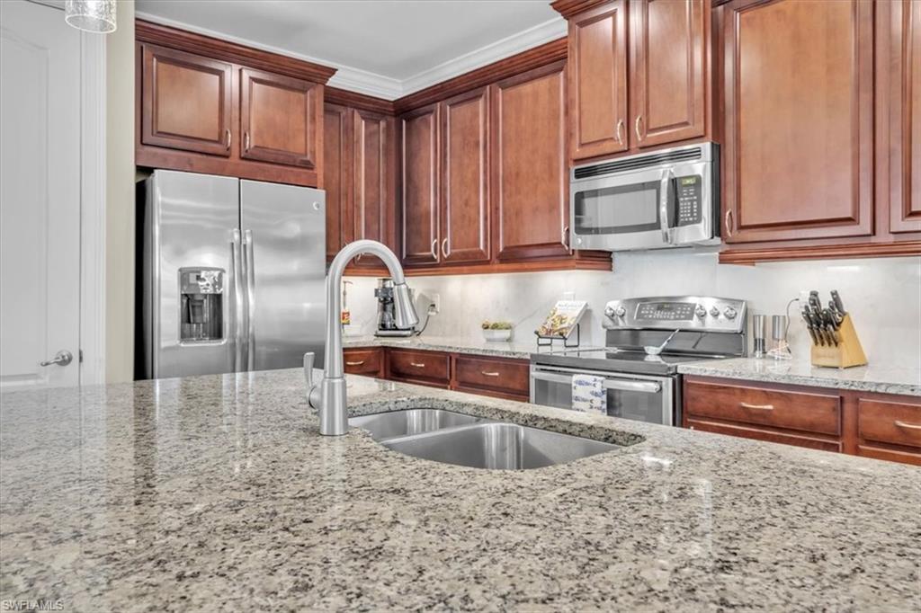 16424 Windsor Way Alva, FL 33920 - Photo 13 of 48 a kitchen with kitchen island granite countertop a sink stainless steel appliances and cabinets