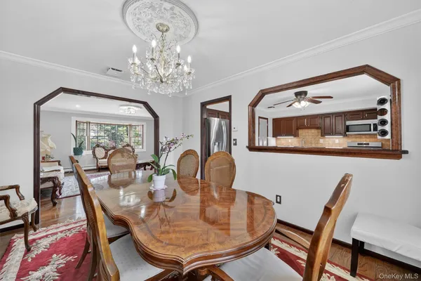 a dining room with furniture a rug and a chandelier