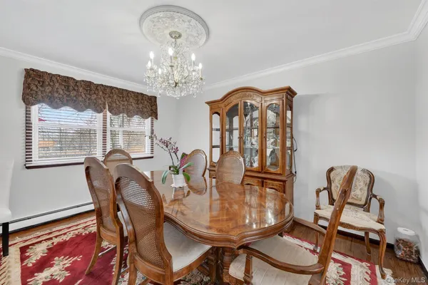 a view of a dining room with furniture and chandelier