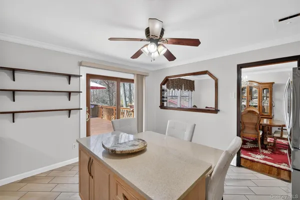 a view of a dining room with furniture and a chandelier fan