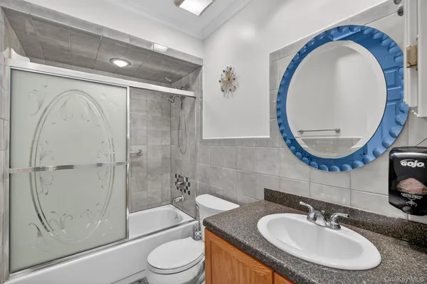 a bathroom with a sink a toilet and a mirror