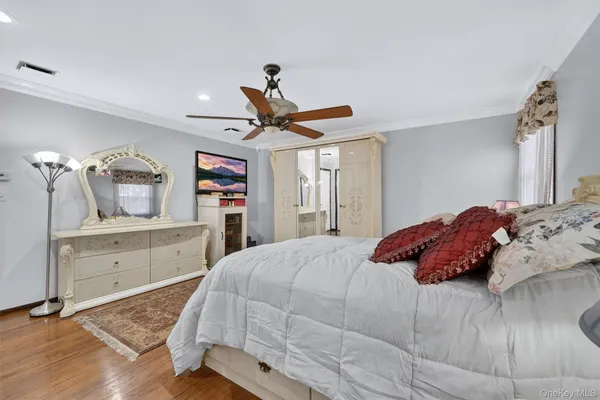 a bedroom with a bed and a dresser