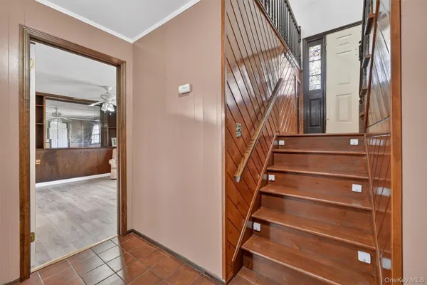 a view of staircase with wooden floor and a bathroom view