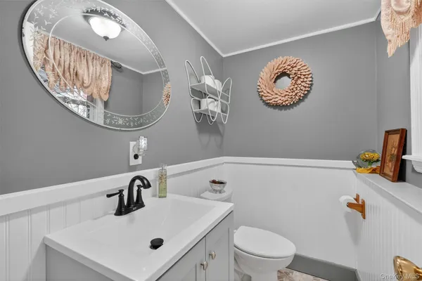 a bathroom with a sink a mirror and vanity