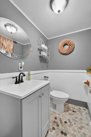 a bathroom with a sink a toilet and a mirror