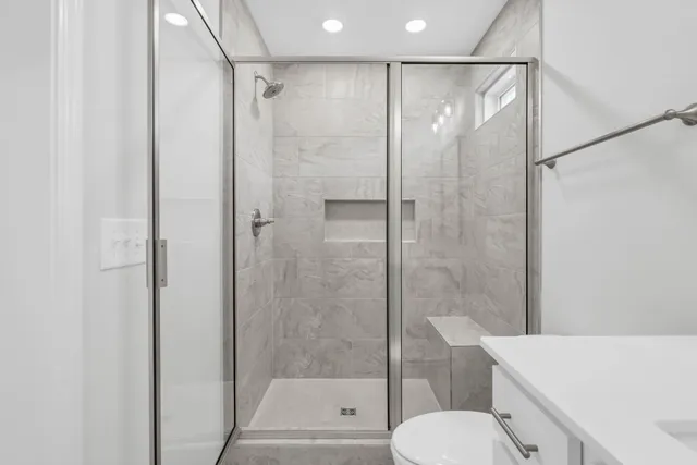 a bathroom with a shower and toilet