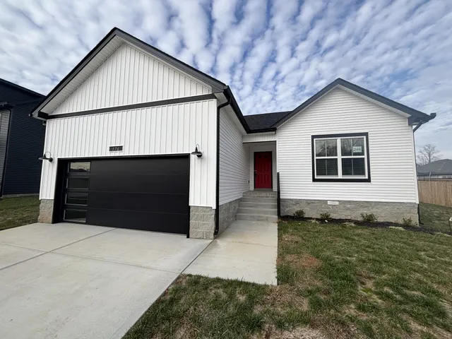a front view of a house with a yard and garage