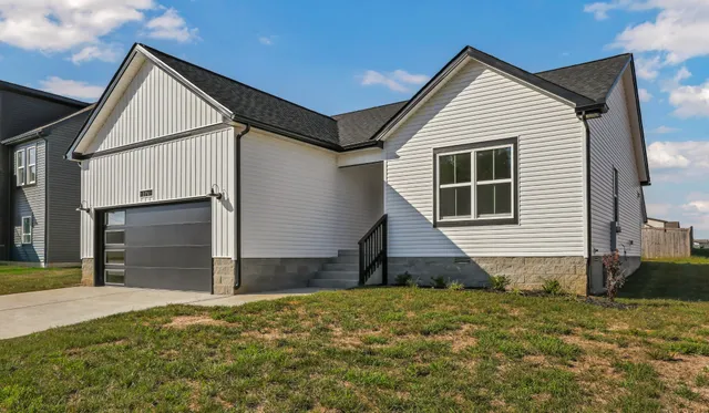a view of backyard of house and wooden deck