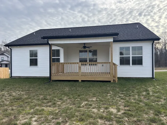 a view of a house with a small yard and wooden floor