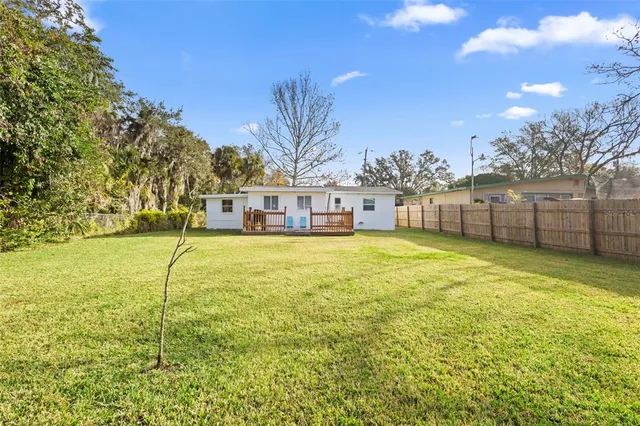 a view of a swimming pool with a yard