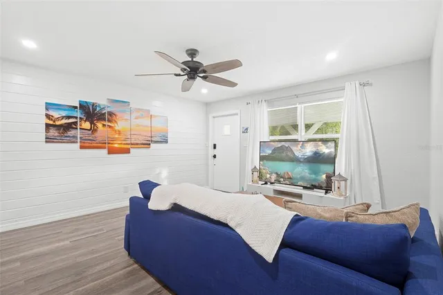 a living room with furniture and a flat screen tv