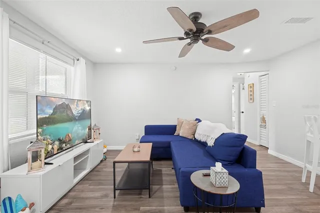 a living room with furniture and wooden floor