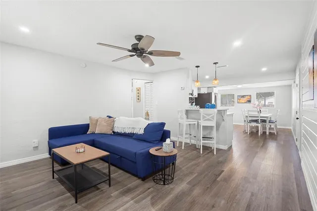 a living room with furniture and wooden floor