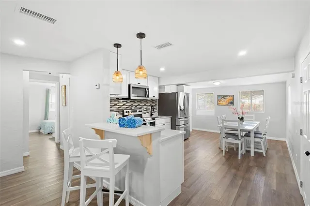a view of a dining room with furniture wooden floor and a rug