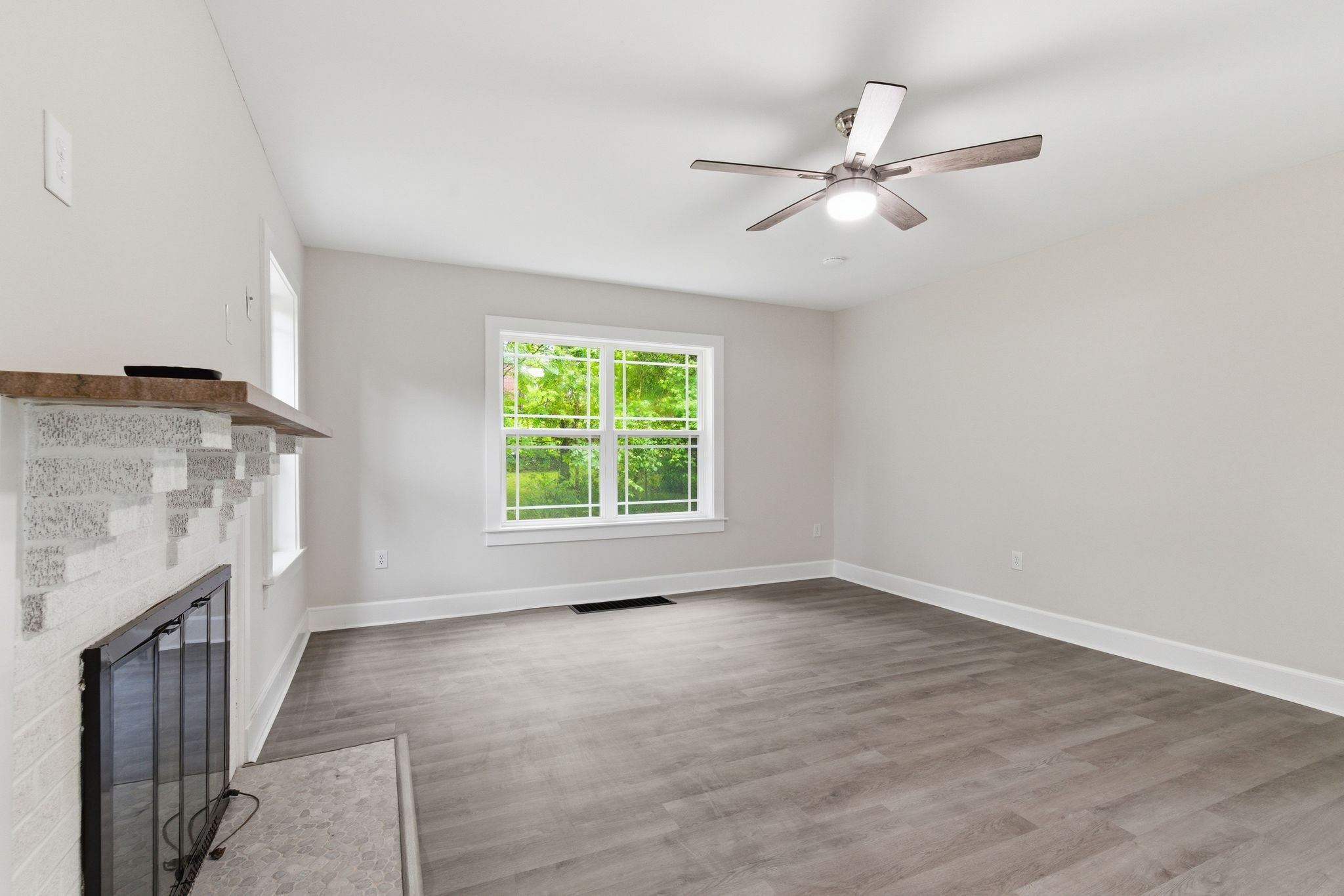 305 South Irwin Street Manchester, TN 37355 - Photo 8 of 40 a view of an empty room with a fireplace and a window