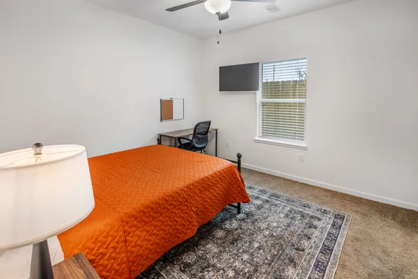 a bedroom with a bed and a window