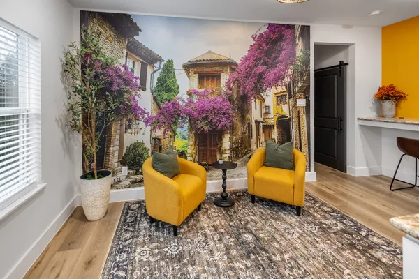 a living room with furniture and wooden floor