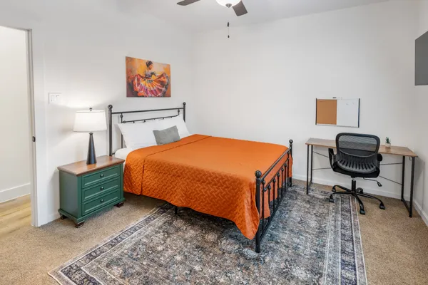 a bed room with a bed and a chair