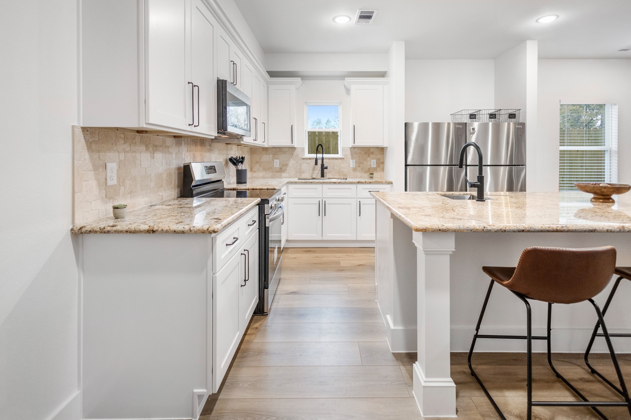 5015 Reed Road Houston, TX 77033 - Photo 6 of 13 a kitchen with stainless steel appliances granite countertop a stove a sink and a refrigerator