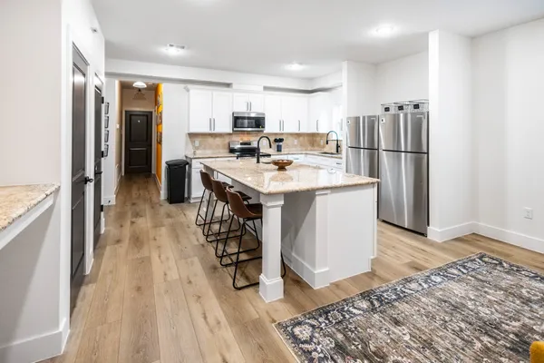a kitchen with stainless steel appliances a refrigerator and a stove top oven