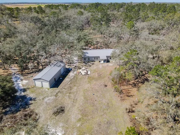 a picture of aerial view of a house with a yard