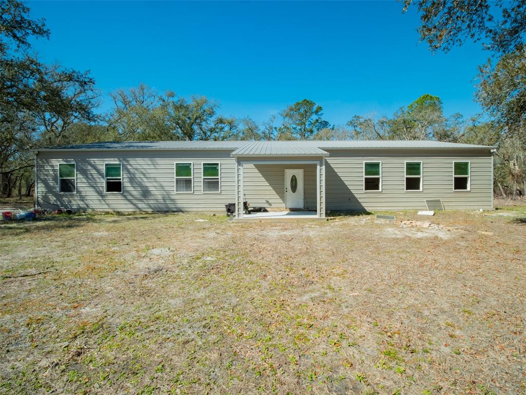 3949 184th Street Wellborn, FL 32094 - Photo 2 of 35 front view of house with a yard