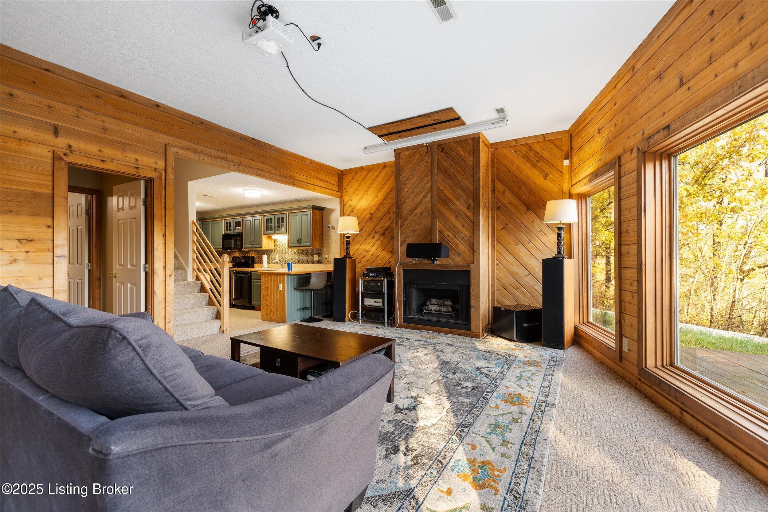 Familyroom open to the kitchen and a wall of windows with stunning views.