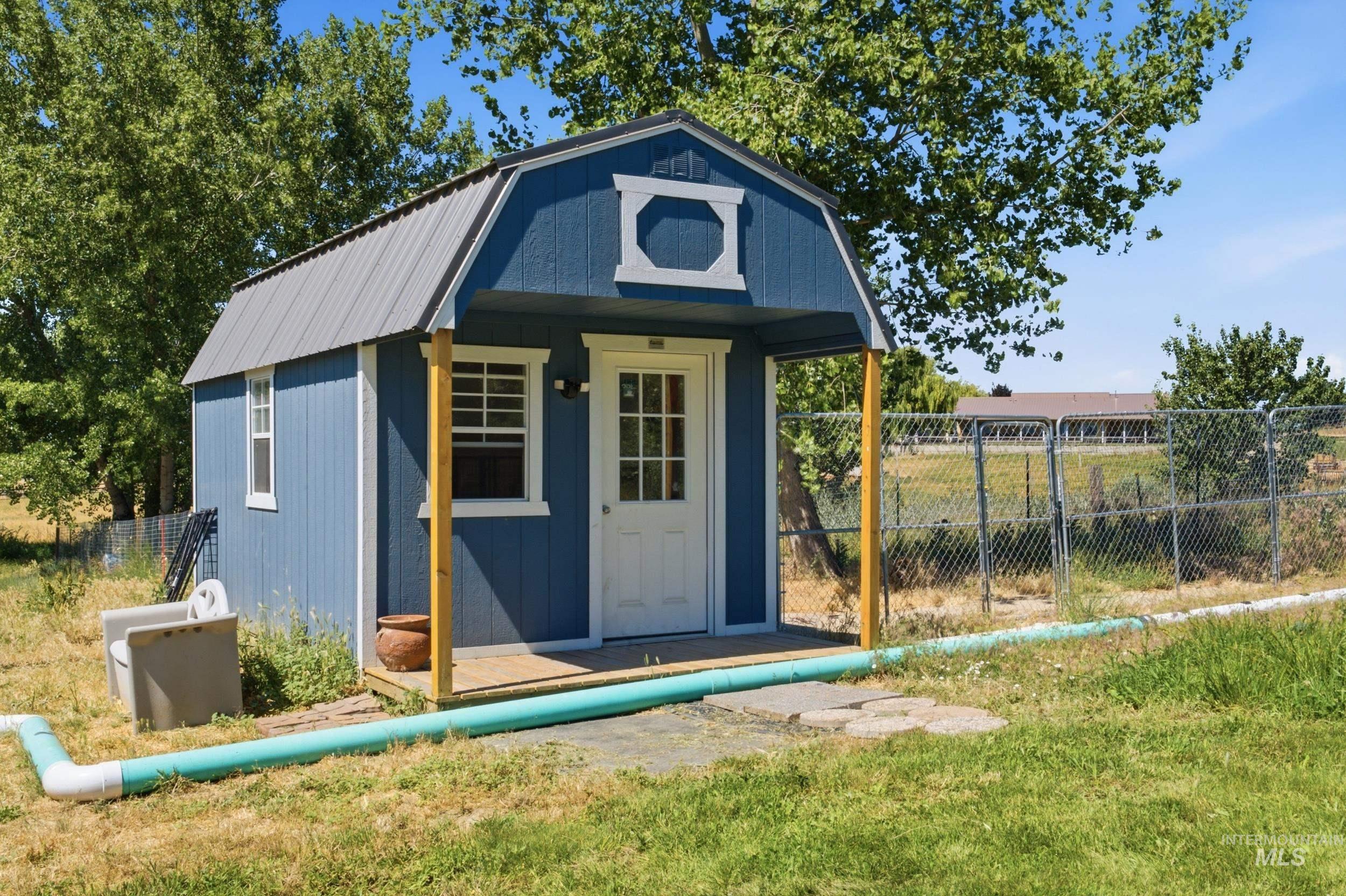 7781 Redmon Road Caldwell, ID 83607 - Photo 11 of 50 Expansive metal-sided shed with a slatted wood roof and exposed wood beams