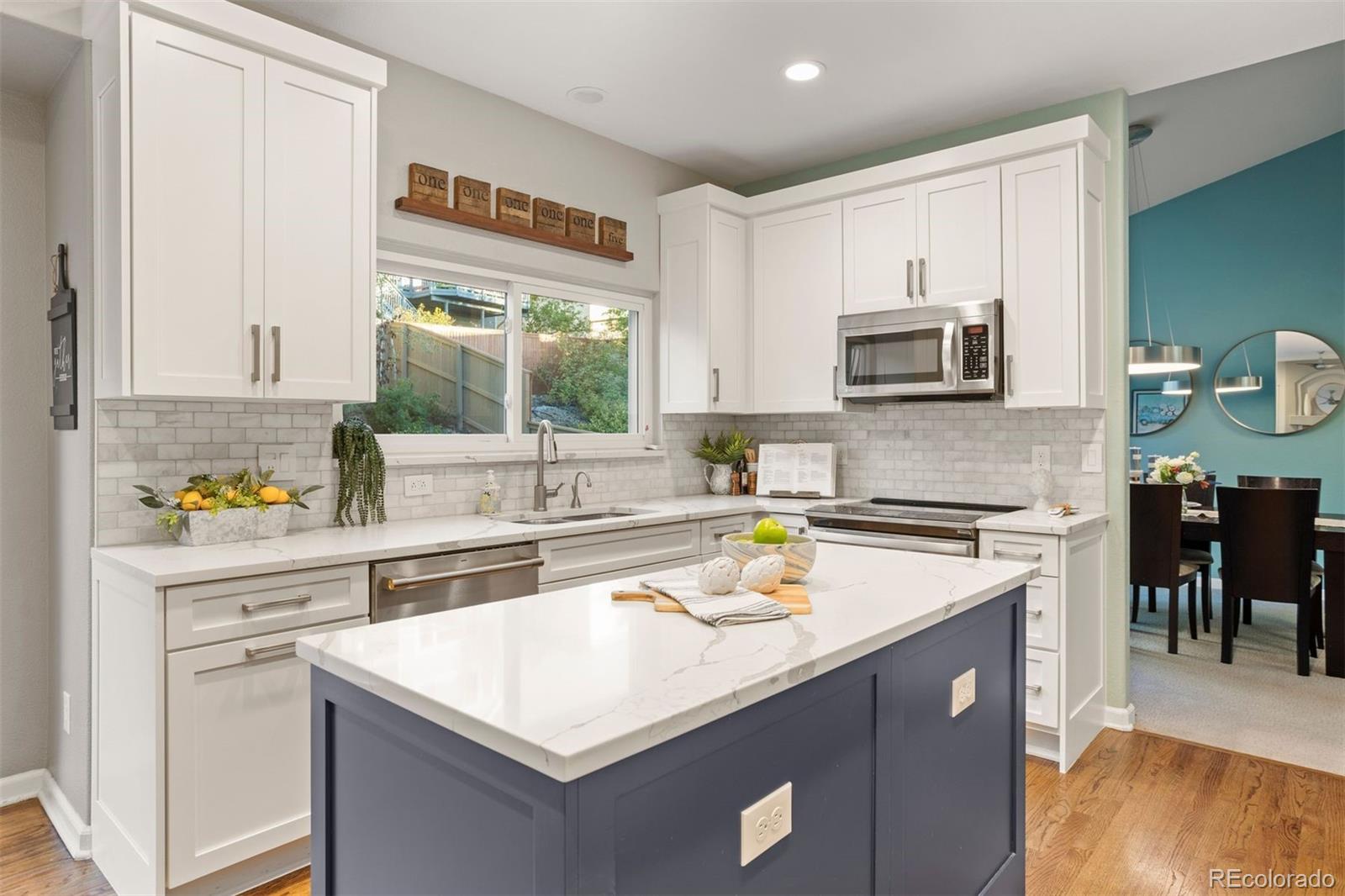 5426 East Knoll Place Highlands Ranch, CO 80130 - Photo 11 of 28 a kitchen with a stove a sink and a microwave