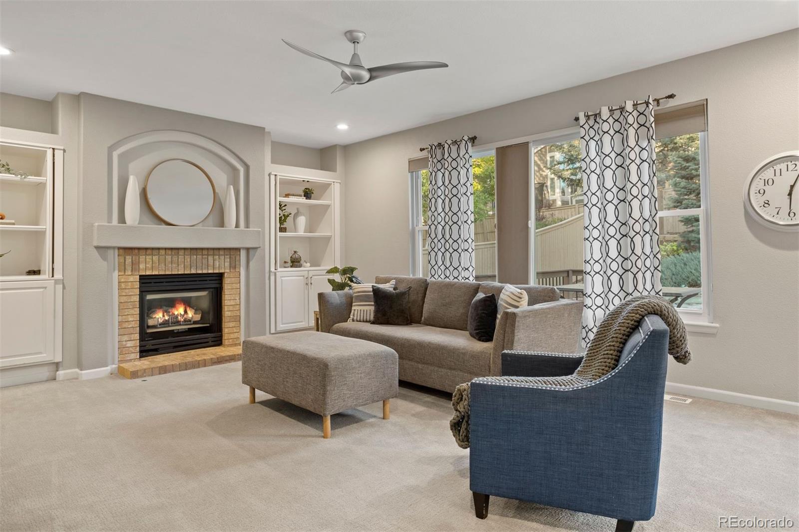 5426 East Knoll Place Highlands Ranch, CO 80130 - Photo 14 of 28 a living room with furniture and a fireplace