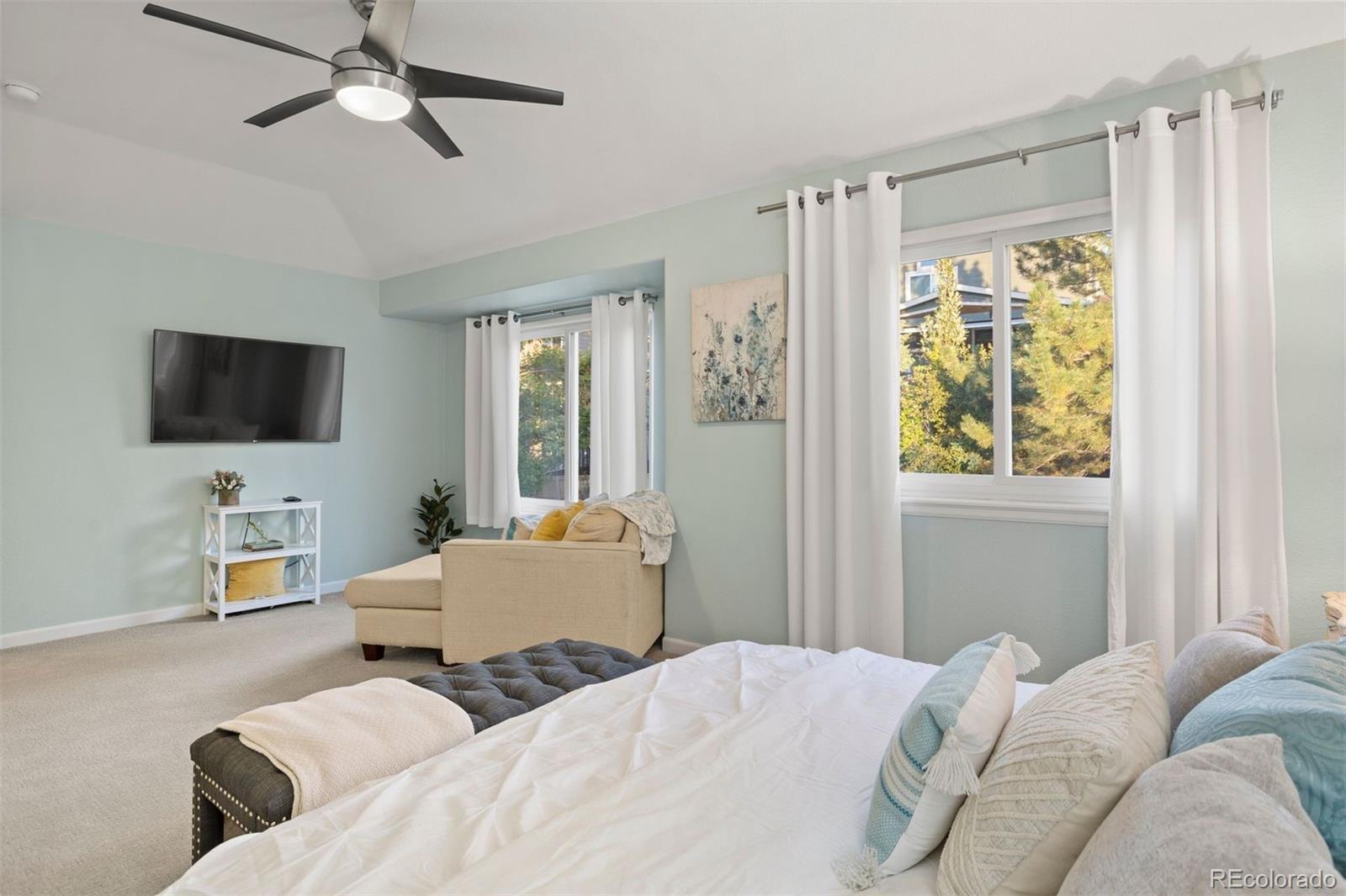 5426 East Knoll Place Highlands Ranch, CO 80130 - Photo 18 of 28 a bedroom with a bed furniture and a flat screen tv