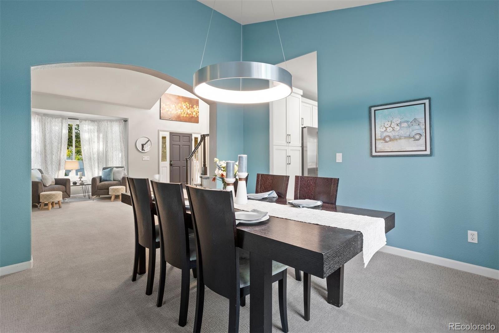 5426 East Knoll Place Highlands Ranch, CO 80130 - Photo 6 of 28 a view of a dining room with furniture and a chandelier