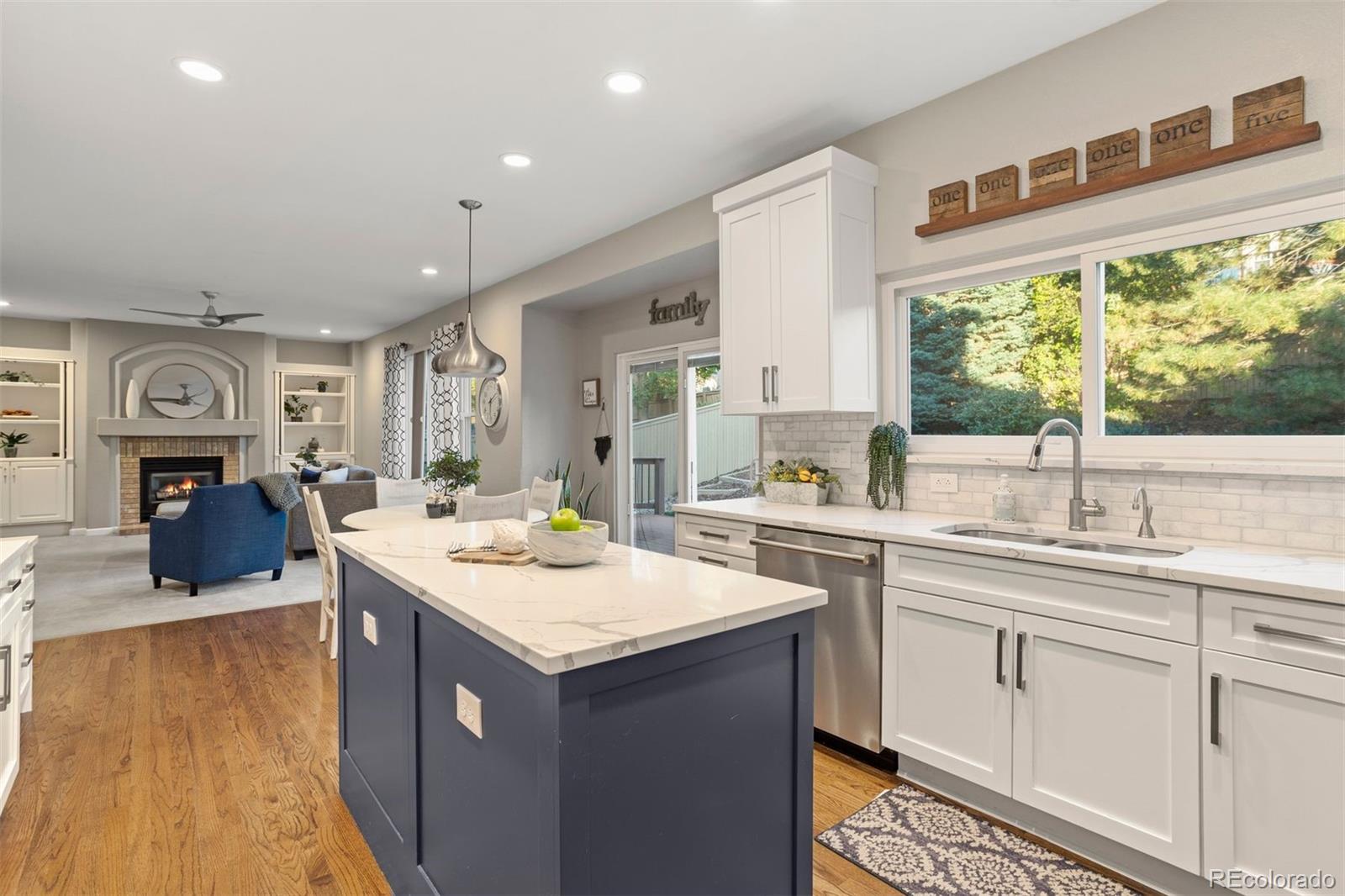 5426 East Knoll Place Highlands Ranch, CO 80130 - Photo 8 of 28 a kitchen with a sink stove and cabinets