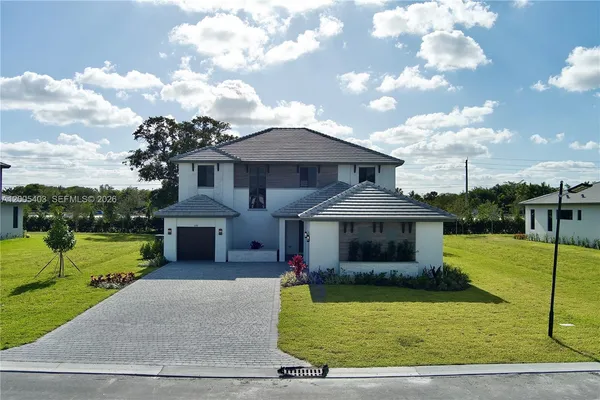 a front view of a house with a yard