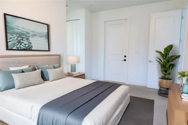 a bedroom with bed and painting on the wall