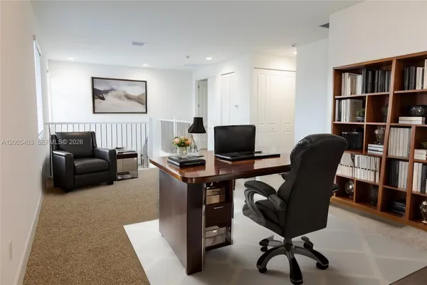 a view of a livingroom with workspace and a couch