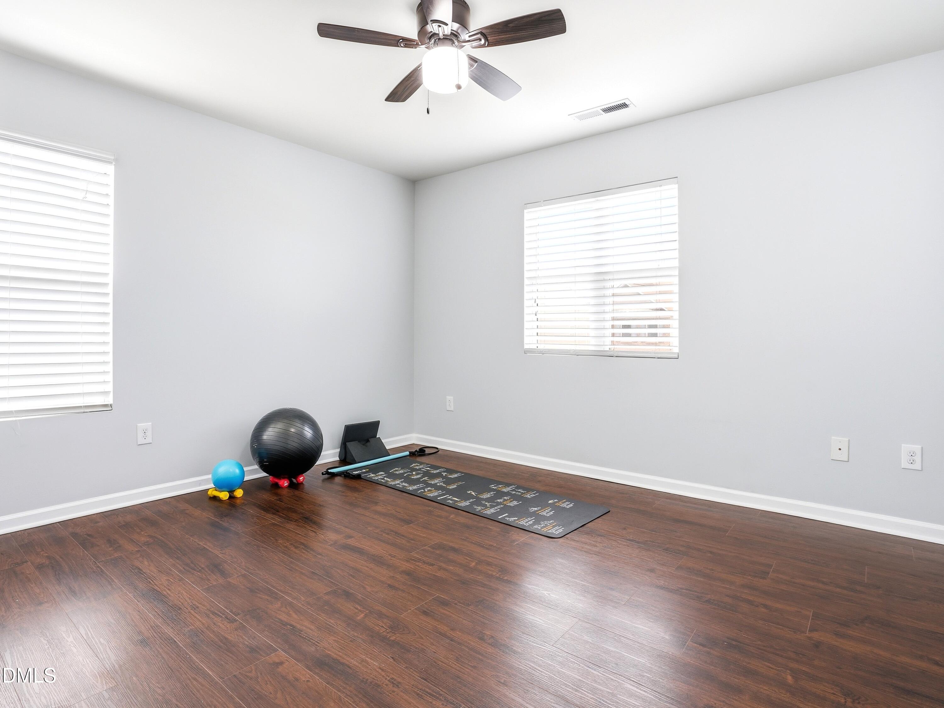 8128 Hovingham Way Raleigh, NC 27616 - Photo 22 of 40 a room with a window and wooden floor