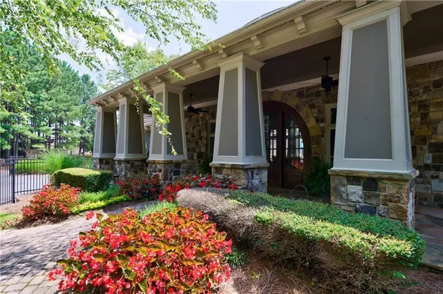 a front view of a house with a yard and garden